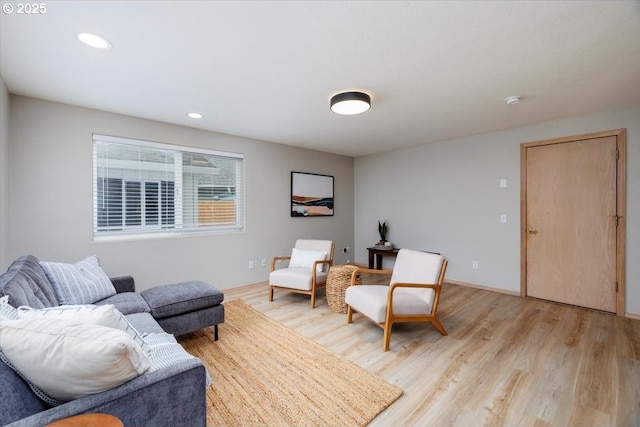 living area with light wood finished floors, recessed lighting, and baseboards