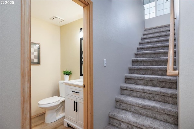 stairway featuring wood finished floors