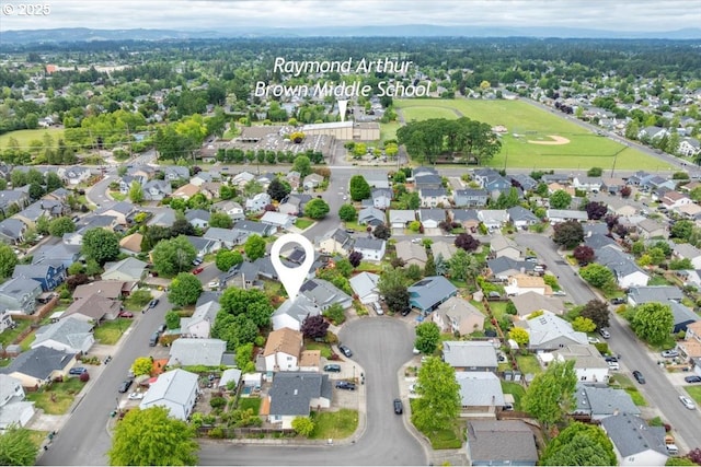 aerial view of property and surrounding area featuring nearby suburban area