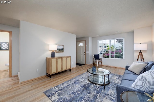 living room featuring light wood-style flooring and baseboards