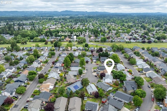 aerial view of property and surrounding area featuring nearby suburban area
