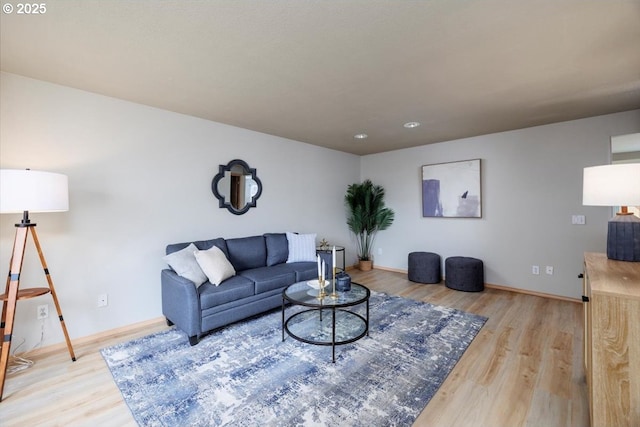 living area featuring light wood-type flooring and baseboards