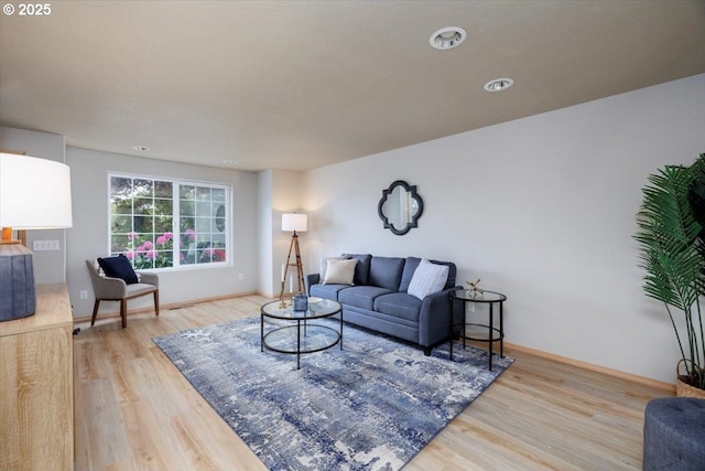 living area with wood finished floors, baseboards, and recessed lighting