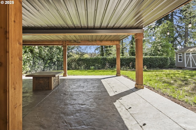 view of patio / terrace featuring a hot tub and fence