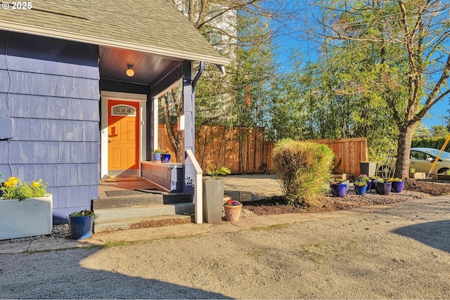 view of exterior entry with fence