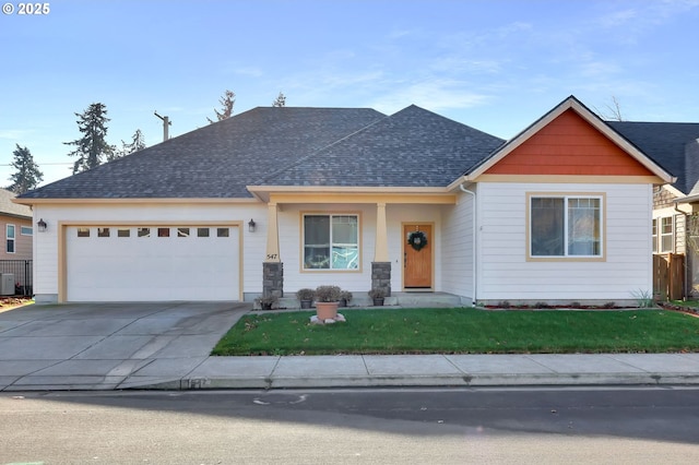 view of front of home with a garage and a front yard