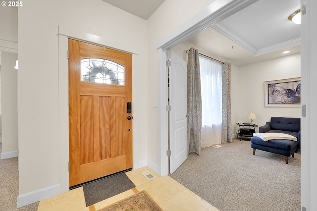 entryway featuring ornamental molding and light colored carpet