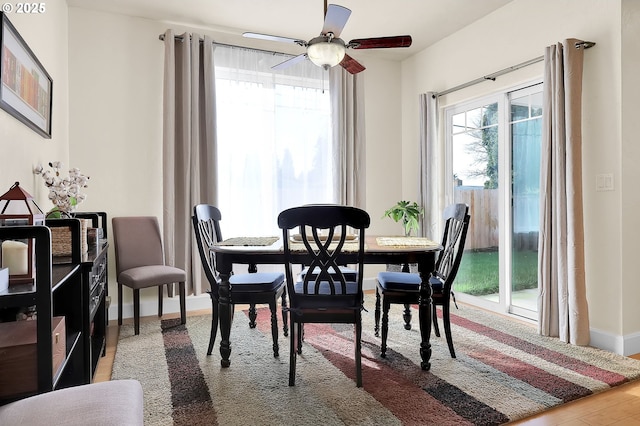 dining area featuring ceiling fan and wood-type flooring