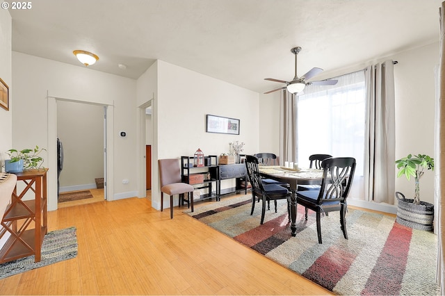 dining area featuring ceiling fan and light wood-type flooring