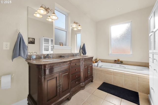 bathroom featuring vanity, tiled tub, and tile patterned floors