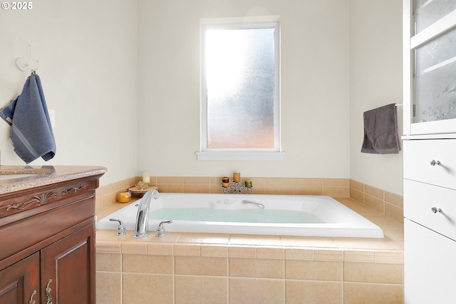 bathroom featuring tiled tub and sink