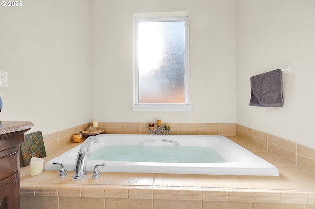 bathroom featuring vanity and a tub to relax in