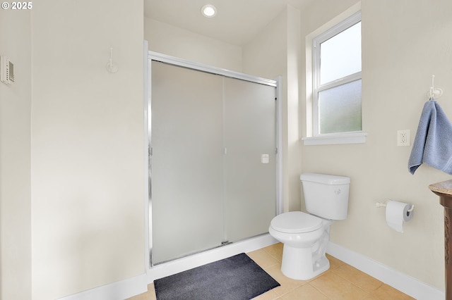 bathroom featuring toilet, tile patterned floors, and walk in shower