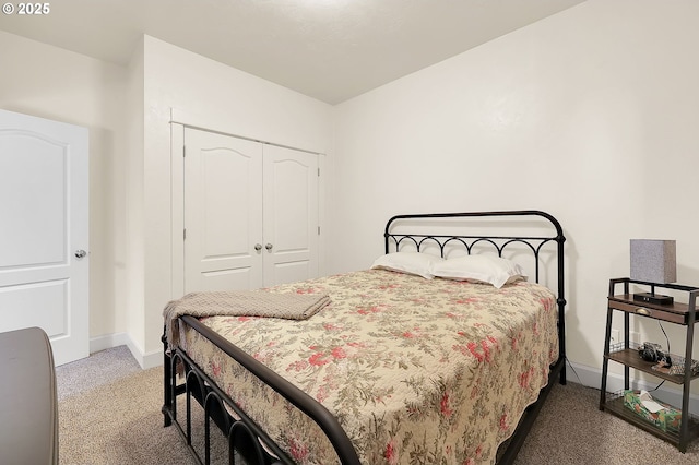 bedroom with a closet and dark colored carpet