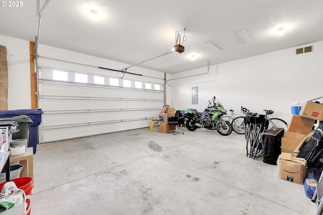 garage featuring a garage door opener and electric panel