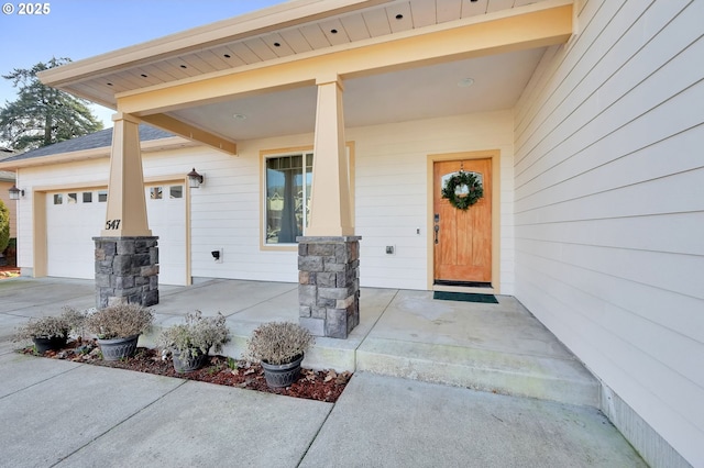 entrance to property with a porch and a garage