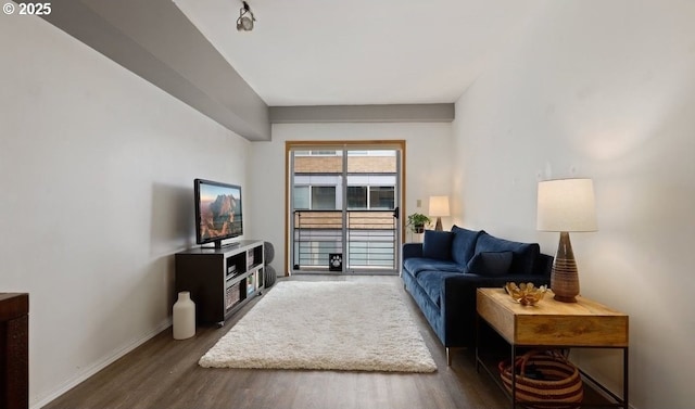 living room featuring wood finished floors and baseboards