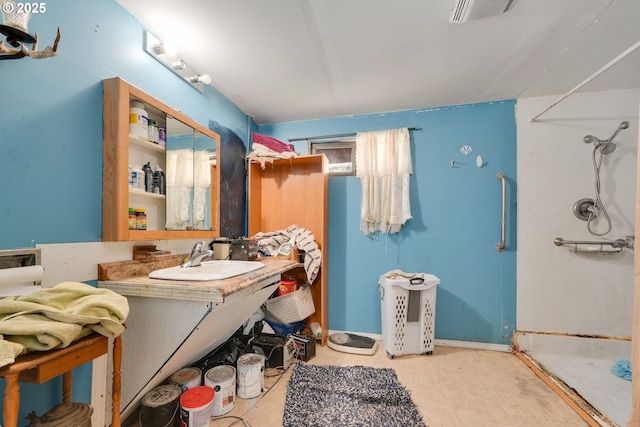 full bathroom featuring vanity, walk in shower, visible vents, and baseboards