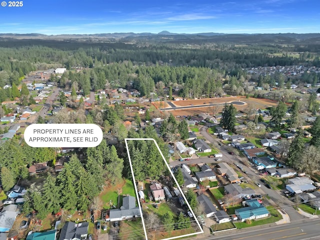 aerial view featuring a mountain view and a view of trees