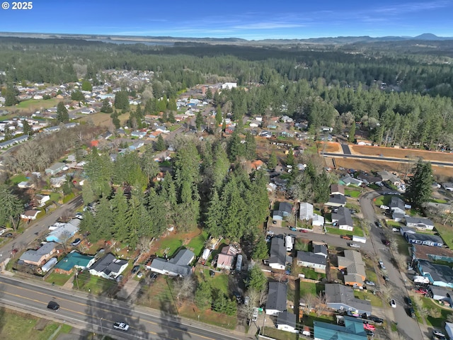 birds eye view of property featuring a residential view and a view of trees