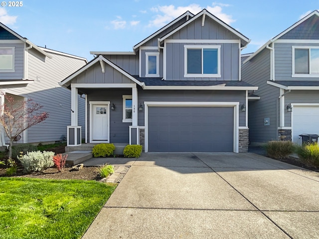 craftsman-style home with board and batten siding, an attached garage, stone siding, and concrete driveway