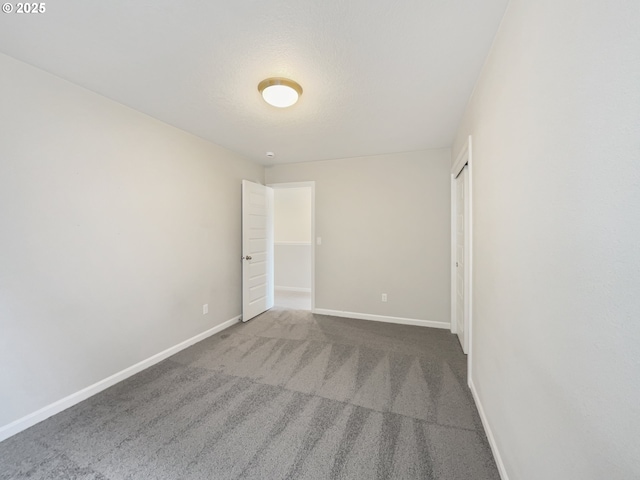 unfurnished bedroom with a closet, baseboards, and carpet floors