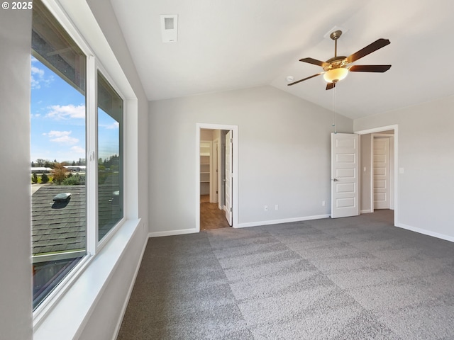 unfurnished bedroom featuring baseboards, ceiling fan, carpet, and lofted ceiling