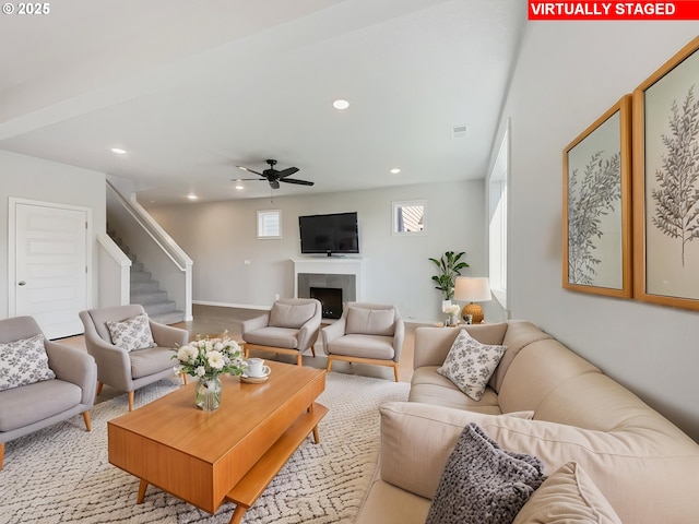 living room with ceiling fan, recessed lighting, a fireplace, and stairs