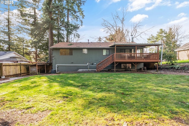 rear view of house with a deck, cooling unit, fence, stairway, and a lawn