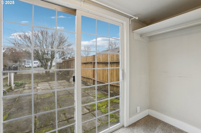 doorway to outside featuring carpet