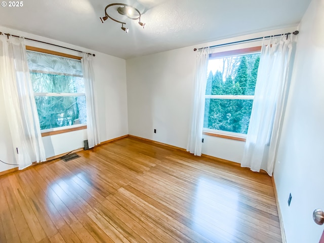 3241 SW Spring Garden St, Portland, OR 97219 - spare room featuring light wood-style floors and healthy amount of natural light