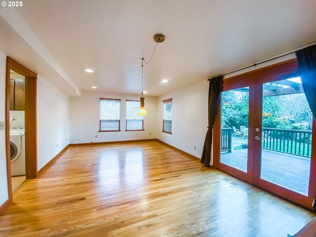 3241 SW Spring Garden St, Portland, OR 97219 - empty room with light wood-type flooring, recessed lighting, washer / dryer, and french doors