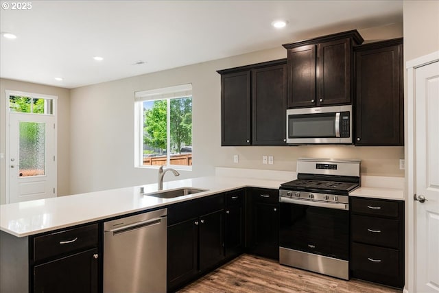 7119 NE 152nd Pl, Vancouver, WA 98682 - kitchen with stainless steel appliances, a sink, a peninsula, healthy amount of natural light, and recessed lighting