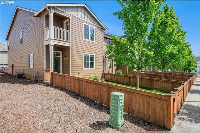7119 NE 152nd Pl, Vancouver, WA 98682 - rear view of property with a balcony, board and batten siding, and cooling unit