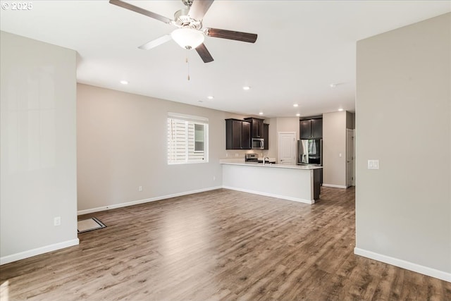 7119 NE 152nd Pl, Vancouver, WA 98682 - unfurnished living room featuring wood finished floors, a ceiling fan, recessed lighting, and baseboards