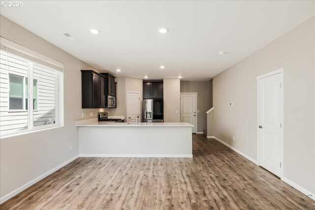7119 NE 152nd Pl, Vancouver, WA 98682 - kitchen featuring stainless steel appliances, a sink, light countertops, light wood-type flooring, and recessed lighting