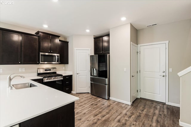 7119 NE 152nd Pl, Vancouver, WA 98682 - kitchen with stainless steel appliances, a sink, wood finished floors, baseboards, and recessed lighting