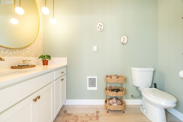 4633 SE 35th Ave Unit B, Portland, OR 97202 - bathroom with vanity, toilet, wood finished floors, and baseboards