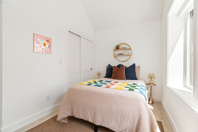 4633 SE 35th Ave Unit B, Portland, OR 97202 - bedroom featuring wood finished floors, a closet, baseboards, and vaulted ceiling