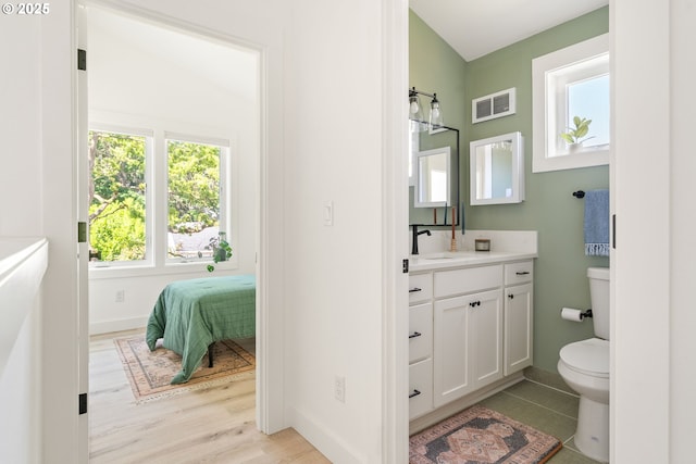 4633 SE 35th Ave Unit B, Portland, OR 97202 - bathroom with vanity, plenty of natural light, toilet, and baseboards