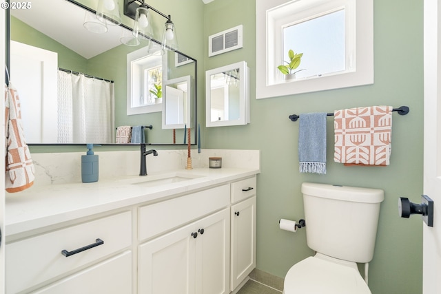 4633 SE 35th Ave Unit B, Portland, OR 97202 - bathroom with vanity, toilet, and vaulted ceiling