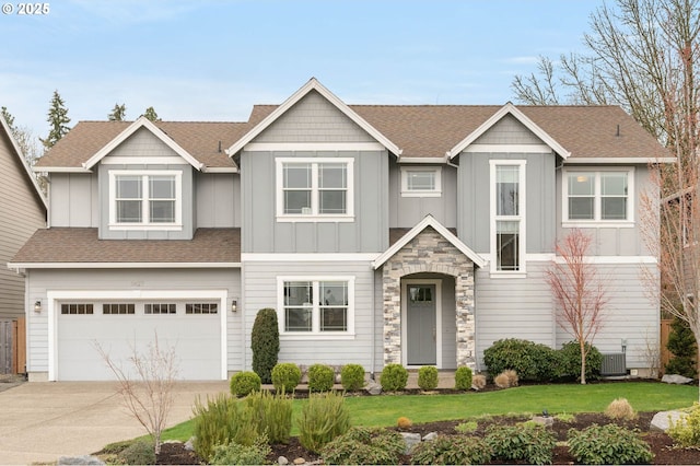 craftsman inspired home featuring central AC unit, board and batten siding, concrete driveway, and an attached garage