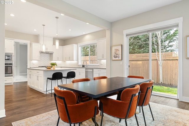 dining area with recessed lighting, baseboards, and wood finished floors