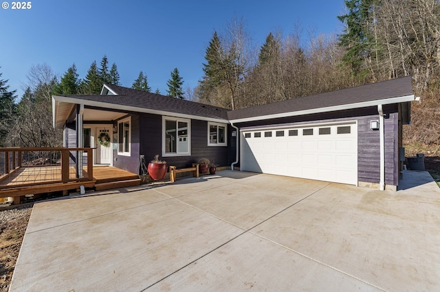 ranch-style house with an attached garage and concrete driveway