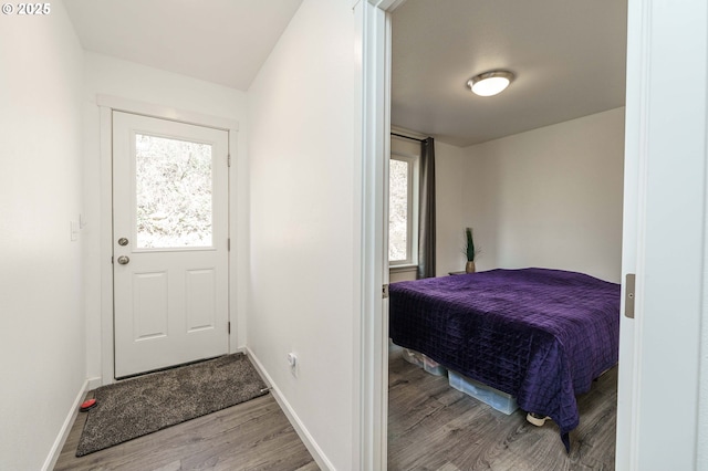 interior space featuring baseboards and wood finished floors