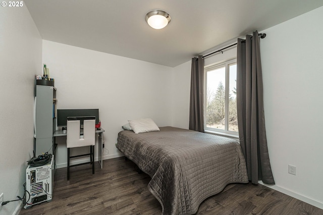 bedroom with baseboards and wood finished floors