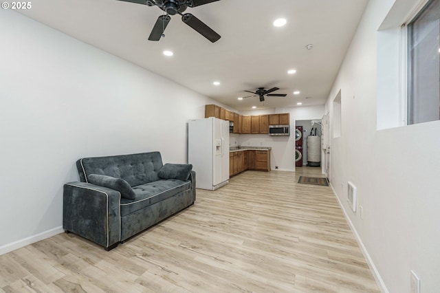 living area with recessed lighting, baseboards, and light wood finished floors