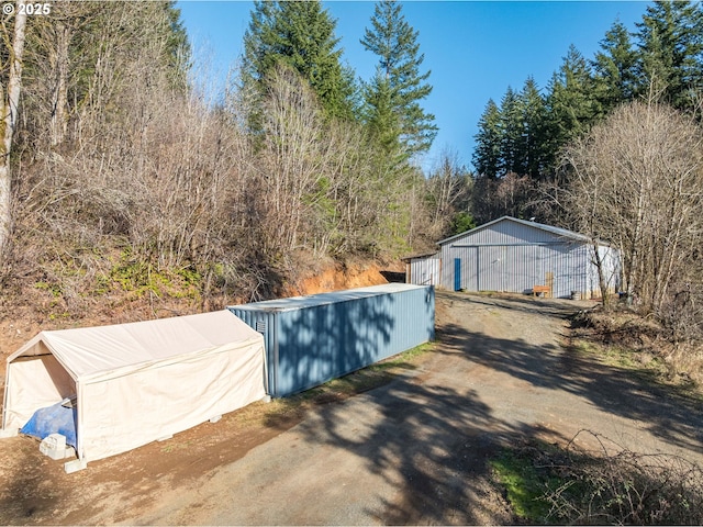 view of swimming pool with an outbuilding and a pole building