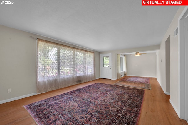 150 Maynard Ave, Eugene, OR 97404 - unfurnished living room with wood finished floors, baseboards, and ceiling fan