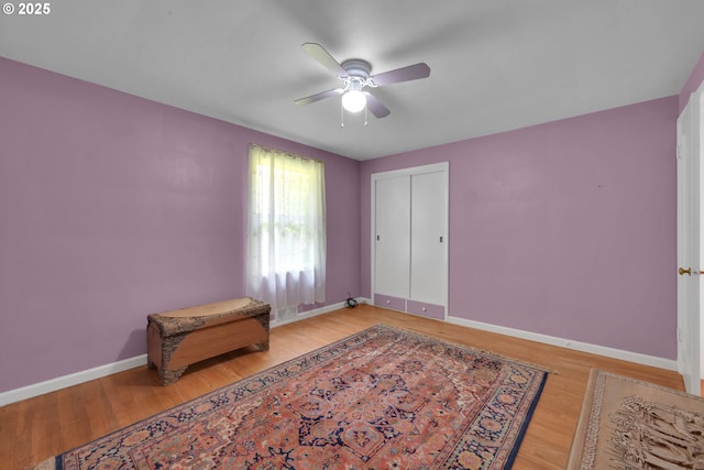 150 Maynard Ave, Eugene, OR 97404 - unfurnished bedroom featuring wood finished floors, baseboards, ceiling fan, and a closet